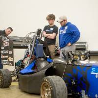 high school students interacting with the laker racer car